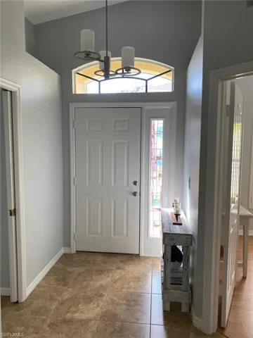 Entrance foyer featuring a high ceiling and hanging lights