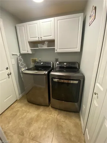 Laundry area with cabinet space and independent washer and dryer
