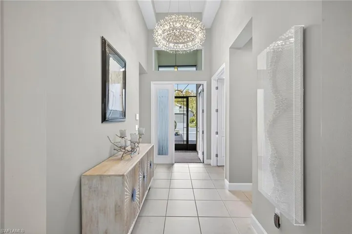 Impressive foyer with tray ceiling and gorgeous chandelier!