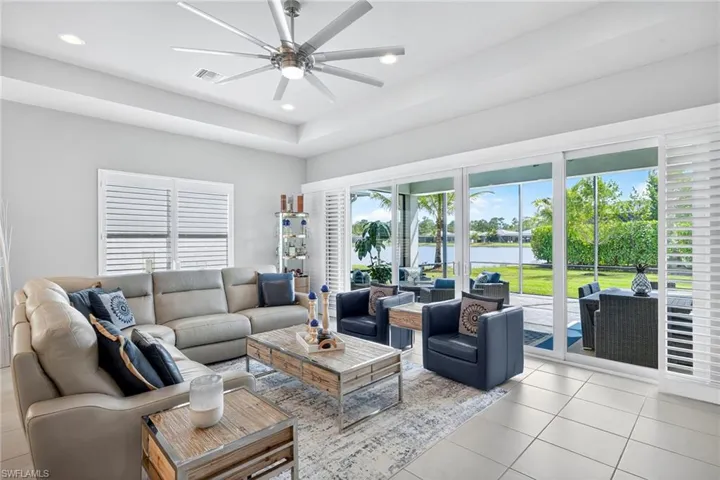 Airy, bright and spacious! This great room comfortably seats 7 plus room to pull up more chairs for book club! Wood plantation shutters across all 4 center opening doors to covered, extended lanai area.