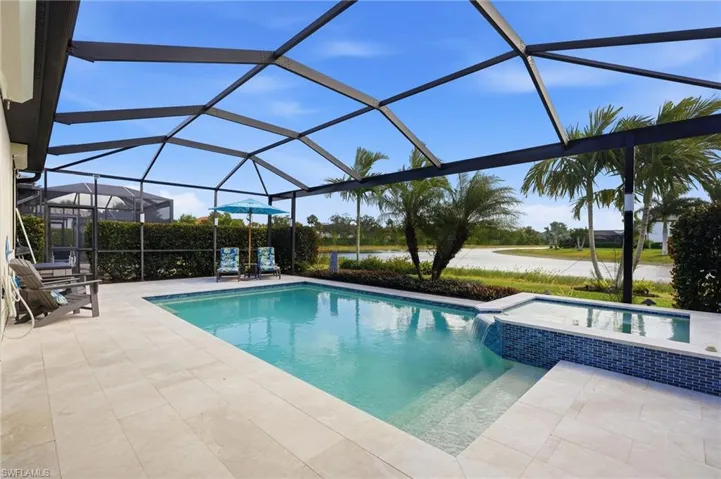 Lanai with outdoor kitchen, automated hurricane shutter, pool and spa with marble pool deck, picture window screen and lanai lights