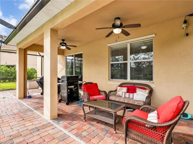 View of patio / terrace with an outdoor hangout area, glass enclosure, a grill, and ceiling fan