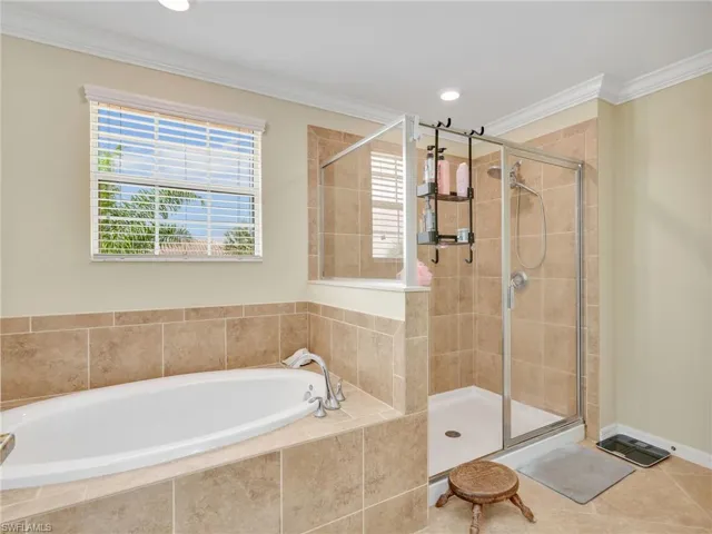 Full bathroom featuring a garden tub, crown molding, a shower stall, and recessed lighting