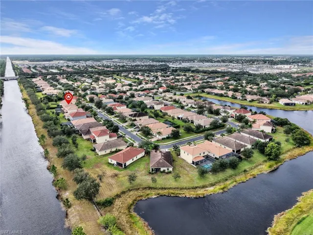 Aerial perspective of suburban area featuring a large body of water