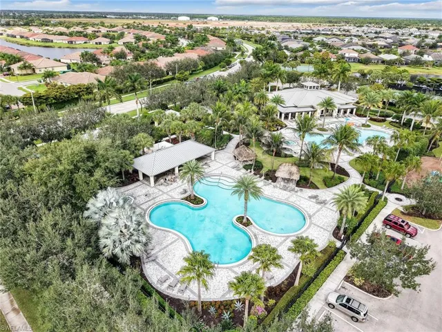 Aerial view of residential area featuring a pool area