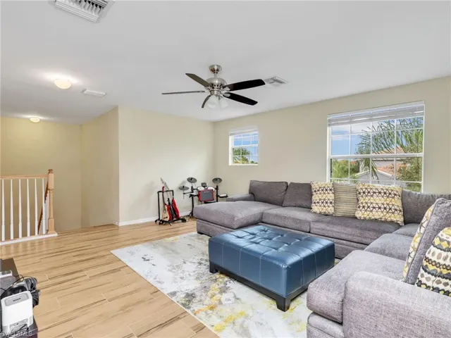 Living area/Loft featuring wood tiled floors and a ceiling fan