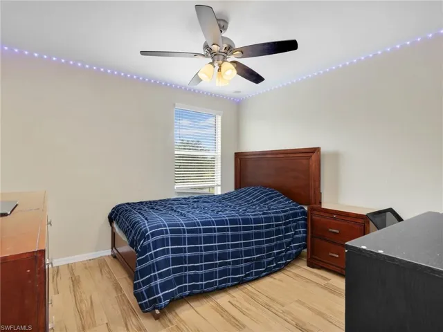 Bedroom with light wood-style floors and ceiling fan