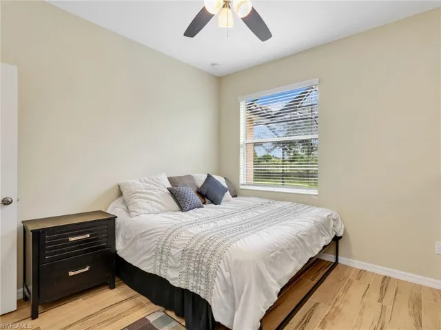 Bedroom with light wood finished floors and ceiling fan