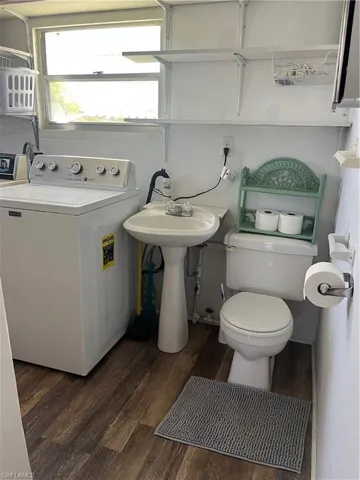 Bathroom featuring washer / clothes dryer and dark wood-style flooring