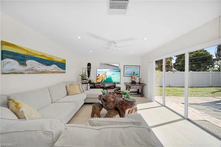 Living area with white walls and light wood-finish flooring