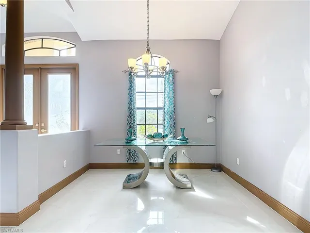 Dining area with an inviting chandelier and a healthy amount of sunlight
