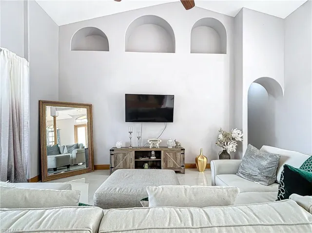 Living room with high vaulted ceiling and ceiling fan