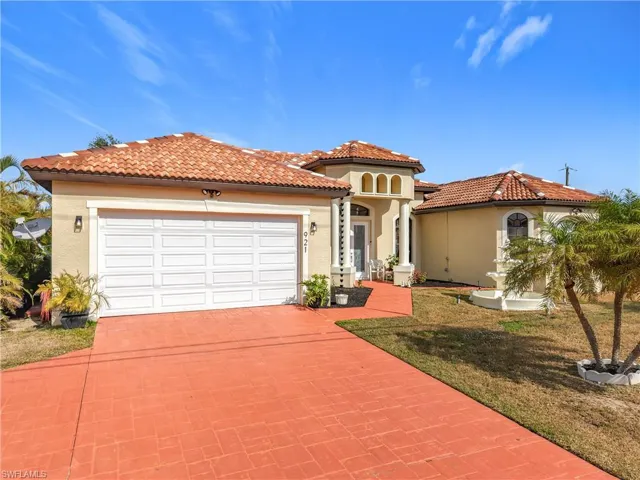 Mediterranean / spanish-style house with a front lawn and a garage