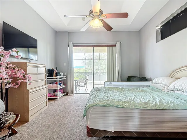 Bedroom featuring access to outside, ceiling fan, and carpet floors