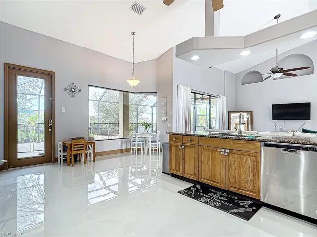 Kitchen with dishwasher, a wealth of natural light, and hanging light fixtures