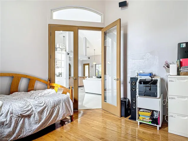 Bedroom featuring french doors and hardwood / wood-style floors