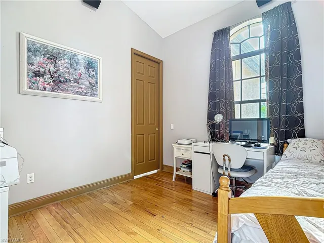 Bedroom featuring hardwood / wood-style floors and vaulted ceiling