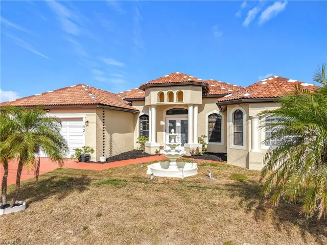 Mediterranean / spanish-style home with a front yard