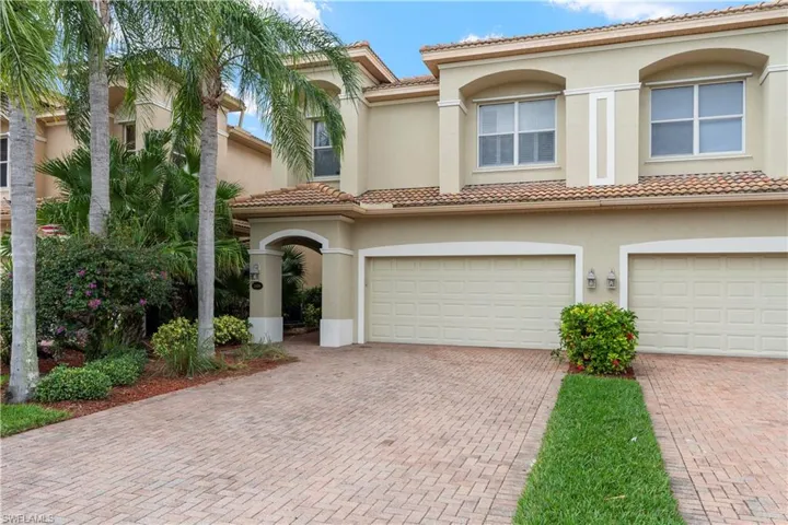Mediterranean / spanish-style house featuring stucco siding, a tiled roof, and an attached garage