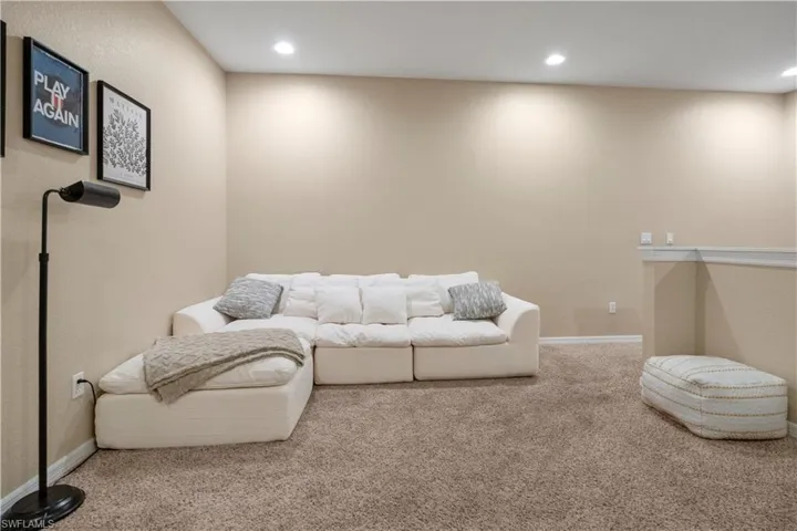 Carpeted living area featuring recessed lighting