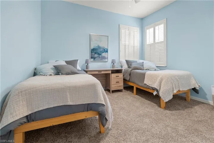 Bedroom with light carpet and ceiling fan