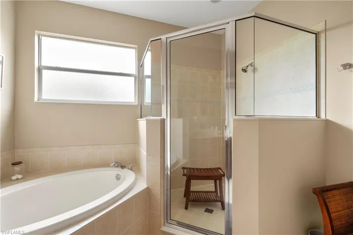 Bathroom featuring a stall shower and a garden tub