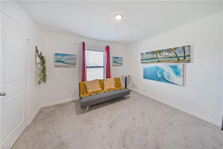 Living area with carpet and baseboards