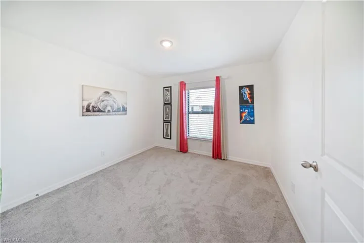 Carpeted empty room with baseboards