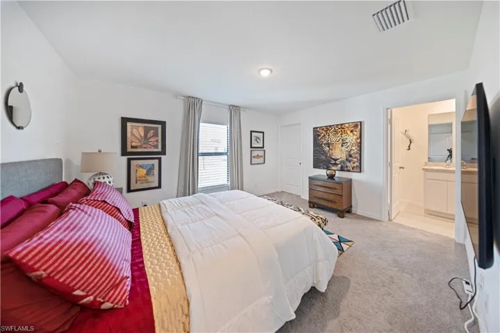 Bedroom with carpet and ensuite bathroom