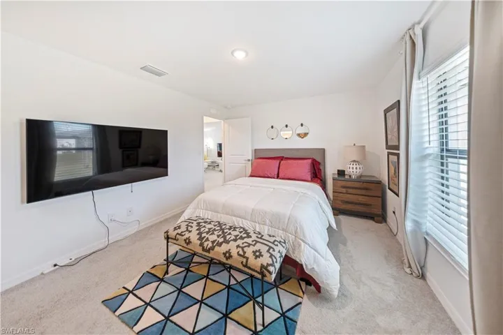 Carpeted bedroom with baseboards