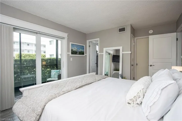 Bedroom featuring a textured ceiling and wood-type flooring