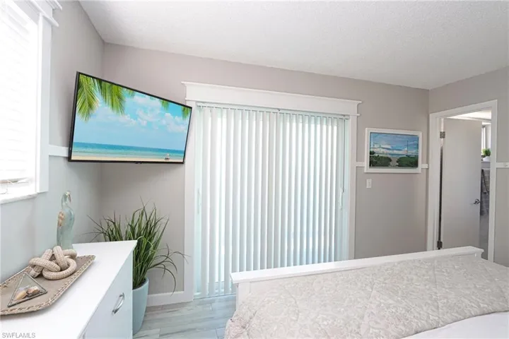 Bedroom featuring light wood finished floors and a textured ceiling