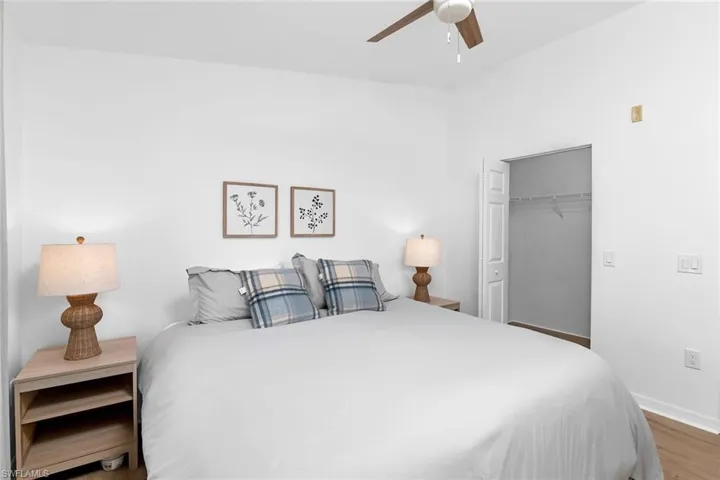 Bedroom featuring wood finished floors, baseboards, a closet, and a ceiling fan