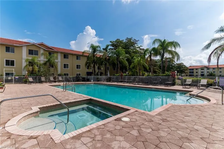 Community pool with a hot tub and a patio