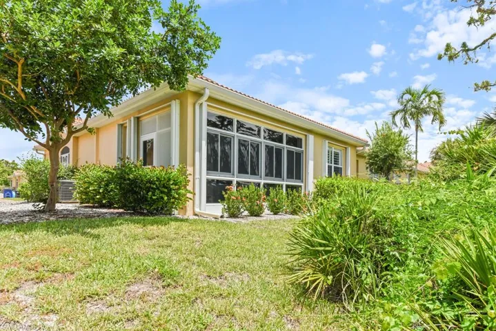 View of property exterior featuring a lawn