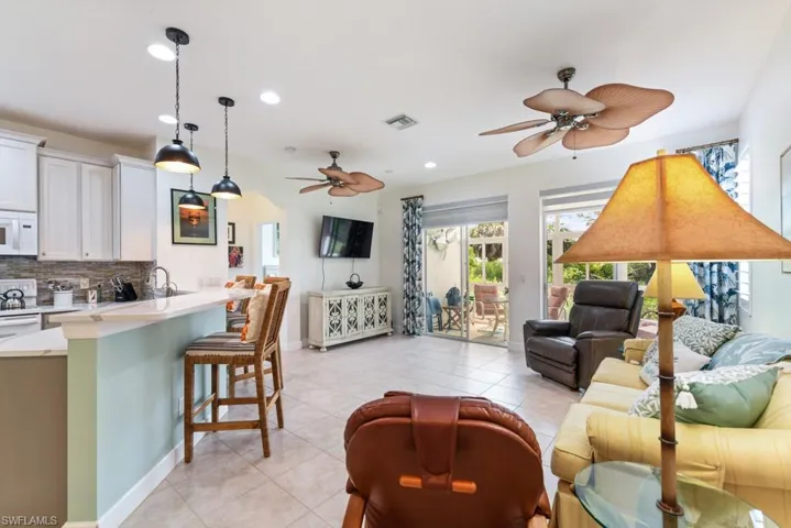 Tiled living room featuring ceiling fan