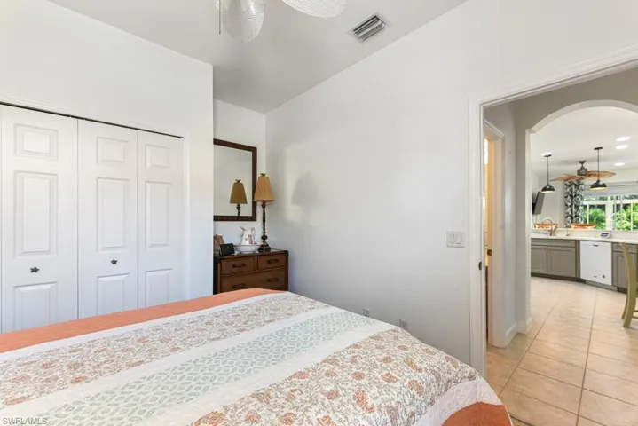 Bedroom featuring ceiling fan, sink, a closet, and light tile patterned flooring