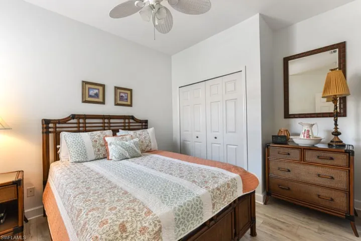 Bedroom with light wood-type flooring, a closet, and ceiling fan