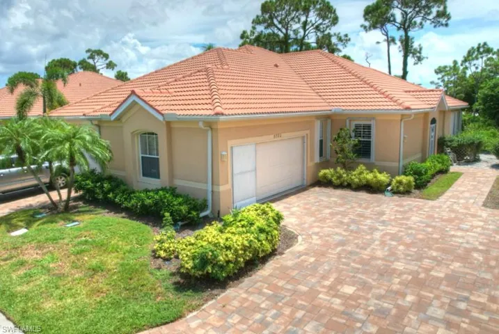 Mediterranean / spanish-style house with a garage