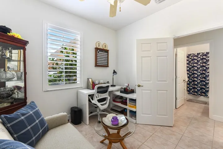 Tiled office featuring ceiling fan