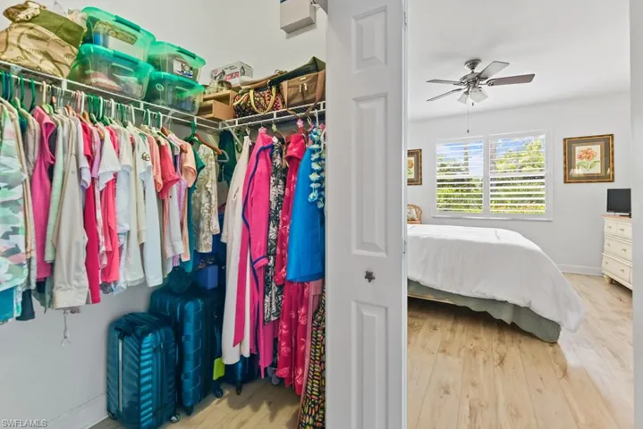 Walk in closet featuring light wood-type flooring and ceiling fan
