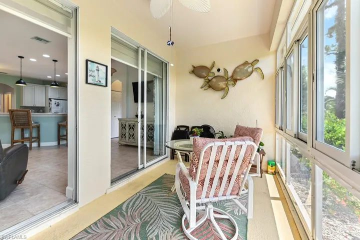 Sunroom / solarium featuring ceiling fan