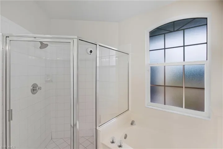 Bathroom featuring a garden tub and a stall shower