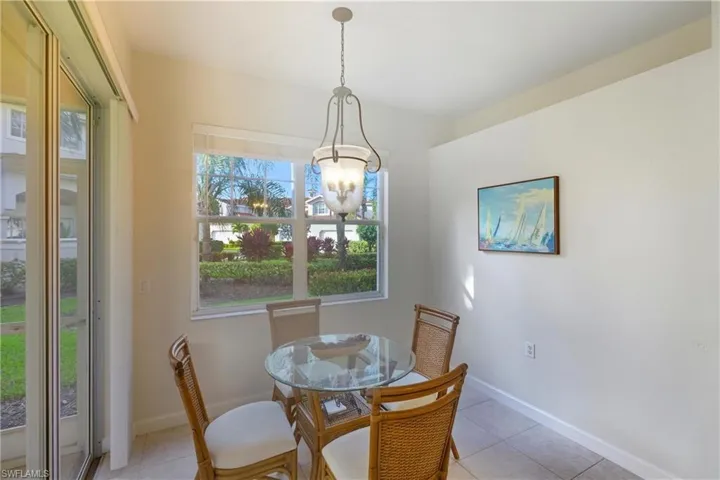 Dining space featuring light tile patterned floors and baseboards