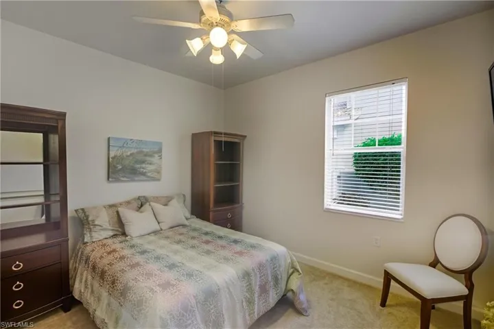 Carpeted bedroom with baseboards and ceiling fan