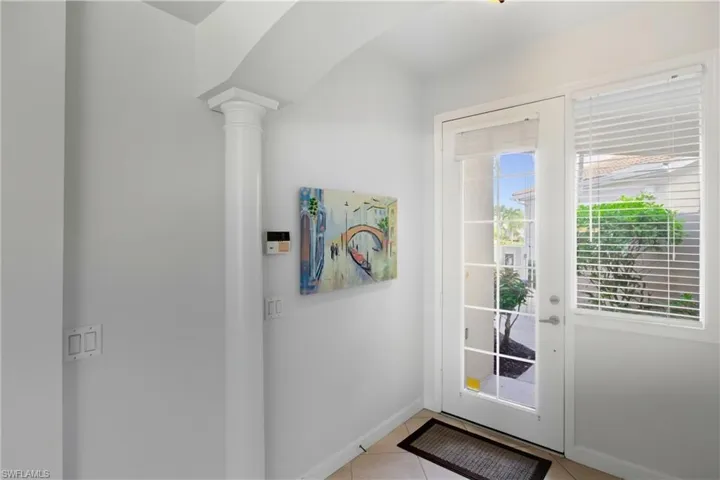Entryway featuring tile patterned flooring and arched walkways