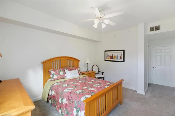 Bedroom with light carpet and ceiling fan