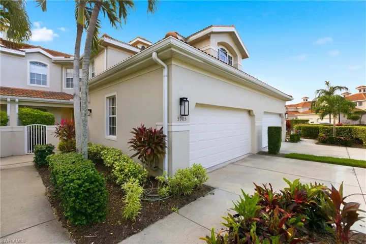 View of home's exterior featuring stucco siding, a garage, concrete driveway, and a gate