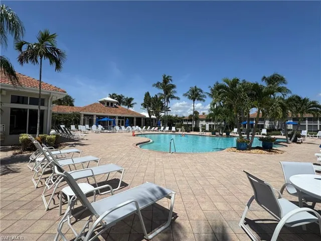 Community pool with a patio