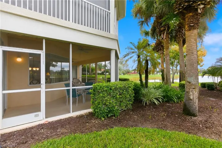View of yard featuring ceiling fan, a sunroom, and a balcony